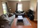 Cozy living room features hardwood floors, neutral paint and comfortable seating at 209 N Lincoln St, Martinsville, IN 46151