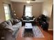Cozy living room featuring comfortable seating, a patterned rug, and hardwood floors at 209 N Lincoln St, Martinsville, IN 46151