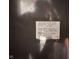 Close-up of a refrigerator label showing model and serial number and date of manufacture at 209 N Lincoln St, Martinsville, IN 46151