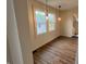 Bright dining area featuring wood floors, pendant lights, and natural light from adjacent windows at 223 E Fordice St, Lebanon, IN 46052