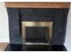 Fireplace with painted brick, wood mantle and metal door at 223 E Fordice St, Lebanon, IN 46052