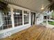 Spacious front porch with wooden floors, ample windows, and stylish lighting creating an inviting entrance at 223 E Fordice St, Lebanon, IN 46052