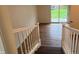 Hallway featuring wood floors, staircase, and sliding doors leading to the outdoor space at 223 E Fordice St, Lebanon, IN 46052