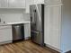 Close-up on kitchen featuring stainless steel appliances, including a refrigerator and dishwasher at 223 E Fordice St, Lebanon, IN 46052
