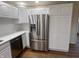 Updated kitchen featuring stainless steel refrigerator, white cabinets, and marble countertops at 223 E Fordice St, Lebanon, IN 46052