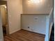 Functional laundry area with shelving, hookups, and wood-look flooring at 223 E Fordice St, Lebanon, IN 46052