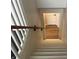 Stairway with neutral carpet runner, white railings and wood handrail at 223 E Fordice St, Lebanon, IN 46052