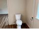 Toilet room with wood floors and a modern toilet and black towel bar at 223 E Fordice St, Lebanon, IN 46052