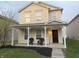 Charming two-story home featuring a welcoming front porch, manicured lawn, and inviting curb appeal at 2327 Bristol Dr, Franklin, IN 46131