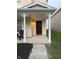 Inviting front porch with decorative columns, mulch landscaping, and a freshly painted front door at 2327 Bristol Dr, Franklin, IN 46131