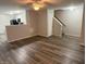 Open-concept living room with wood flooring, a staircase, and views into the modern kitchen at 2327 Bristol Dr, Franklin, IN 46131