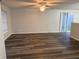 Bright living room featuring wood flooring, neutral paint, a ceiling fan, and sliding glass doors at 2327 Bristol Dr, Franklin, IN 46131