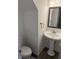 Cozy powder room with pedestal sink, framed mirror, and neutral paint for a minimalist feel at 2327 Bristol Dr, Franklin, IN 46131