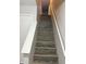 Wood staircase with white railing and neutral paint creating a clean and modern transition between floors at 2327 Bristol Dr, Franklin, IN 46131