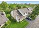 High aerial view of townhome with stonework chimney, and well-kept landscaping at 2430 Spring Hill Ct, Indianapolis, IN 46268