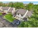 Eye-level aerial view of townhome featuring well-manicured lawn and two-car garage at 2430 Spring Hill Ct, Indianapolis, IN 46268
