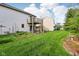 Spacious backyard featuring a large grass lawn and a deck with stairs at 2430 Spring Hill Ct, Indianapolis, IN 46268