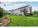 Spacious backyard featuring a large grass lawn and a deck with stairs at 2430 Spring Hill Ct, Indianapolis, IN 46268