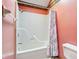 Bathroom tub and shower combo with pink walls at 2430 Spring Hill Ct, Indianapolis, IN 46268