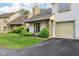 Welcoming exterior with well-kept lawn, and a bench by the front door at 2430 Spring Hill Ct, Indianapolis, IN 46268