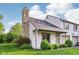 A lovely townhome featuring a striking stone chimney and mature landscaping at 2430 Spring Hill Ct, Indianapolis, IN 46268