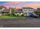 Exterior shot of the home showcasing its well-kept lawn, attached garage, and attractive facade under a colorful sky at 2430 Spring Hill Ct, Indianapolis, IN 46268