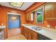 Eat-in kitchen featuring a stainless steel sink, wood cabinets, and a view into the adjacent dining area at 2430 Spring Hill Ct, Indianapolis, IN 46268