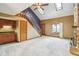 Cozy living room with skylights and a wood staircase with oak accents at 2430 Spring Hill Ct, Indianapolis, IN 46268