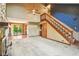 Open living space with a staircase leading to the second floor and an open floor plan at 2430 Spring Hill Ct, Indianapolis, IN 46268