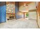 Spacious living room featuring a stone fireplace and sliding glass doors at 2430 Spring Hill Ct, Indianapolis, IN 46268
