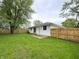 A grass yard with privacy fence in a suburban neighborhood setting offers space to run at 2431 Timbercrest Dr, Columbus, IN 47203