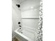 Modern bathroom features white subway tile, dark fixtures, and a sleek tub/shower combination at 2431 Timbercrest Dr, Columbus, IN 47203