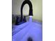 Bathroom sink featuring a black faucet with blue lighting and stone countertop at 2431 Timbercrest Dr, Columbus, IN 47203