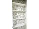 Closet with white shelving and decorative floral wallpaper at 2431 Timbercrest Dr, Columbus, IN 47203