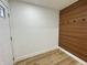 Entryway featuring a coat rack on a modern accent wall, with natural-looking light-toned floors at 2431 Timbercrest Dr, Columbus, IN 47203