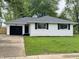 Charming single-story home with a brick exterior, black shutters, and a well-manicured front lawn at 2431 Timbercrest Dr, Columbus, IN 47203