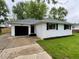 Charming single-story home with a brick exterior, black shutters, and a well-manicured front lawn at 2431 Timbercrest Dr, Columbus, IN 47203