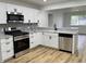 Modern kitchen featuring granite countertops, stainless steel appliances, and light-toned floors at 2431 Timbercrest Dr, Columbus, IN 47203