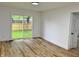 Light-filled living room with new wood flooring and sliding glass door to backyard at 2431 Timbercrest Dr, Columbus, IN 47203
