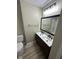 Stylish bathroom featuring double sinks, a large mirror, and a shower reflected in the mirror at 2453 Larnie Ln, Indianapolis, IN 46219