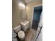 Compact bathroom featuring a toilet, vanity, and a mirror with a view to the bedroom at 2453 Larnie Ln, Indianapolis, IN 46219