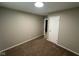 Carpeted bedroom showcasing neutral paint, a spacious closet, and a light fixture at 2453 Larnie Ln, Indianapolis, IN 46219