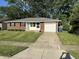Charming single-story brick home with a well-manicured lawn and attached garage at 2453 Larnie Ln, Indianapolis, IN 46219