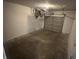 Spacious garage with concrete flooring and a functional, partially open, overhead garage door at 2453 Larnie Ln, Indianapolis, IN 46219