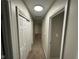 Neutral hallway featuring carpet floors, fresh paint, a sliding door closet, and a light fixture at 2453 Larnie Ln, Indianapolis, IN 46219