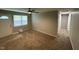 Inviting living room with a ceiling fan, cozy carpet, and a view of the front door at 2453 Larnie Ln, Indianapolis, IN 46219