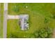 Aerial view of the home with a well-manicured lawn and surrounding trees at 2708 N Buck Creek Rd, Greenfield, IN 46140