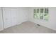 A bright bedroom with a window and double closet, offering a peaceful retreat with great storage at 2708 N Buck Creek Rd, Greenfield, IN 46140