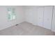 A bedroom with a window and double closets, offering great storage and natural light at 2708 N Buck Creek Rd, Greenfield, IN 46140