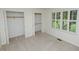 A bright bedroom featuring walk-in closets and a window with shutter, enhancing the space and storage at 2708 N Buck Creek Rd, Greenfield, IN 46140